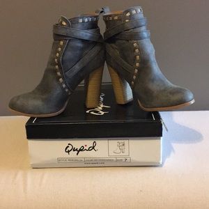Woman’s grey distressed ankle boots